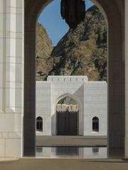 Wall Mural - Medieval historic old house facades and stone building ancient town city skyline with palace, palm trees and small alleys in Muscat, Oman city center downtown with flower parks 1001 Arabian Nights