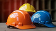© ASHFAQ - Orange, yellow, and blue hard safety helmet hats for safety projects