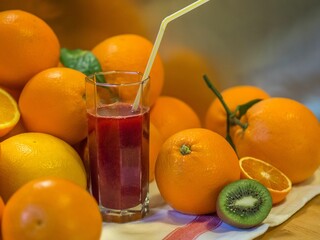 Canvas Print - Closeup of a glass of fruit juice with oranges.