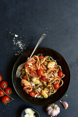 Wall Mural - Pasta with mussels and grilled tomato in spicy sauce. Top view with copy space.