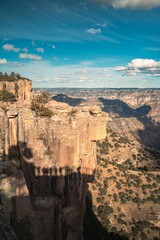 Sticker - Aerial shot of Copper Canyon and the shadow of tourists on the red rocks