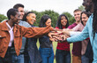 © Vittorio Gravino - Large group of Multicultural community of friends socializing outdoors and having fun together