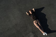 © blackday - Top view of young man carefree lying on the asphalt