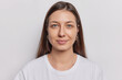 © wayhome.studio  - Portrait of good looking brunette woman with natural eauty healthy skin straight hair looks directly at camera dressed in casual t shirt isolated on white background. Lovely young female model indoor
