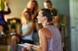 © Flamingo Images - Yoga teacher talking with her class