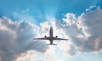 White passenger airplane flying in the sky amazing clouds in the background - Travel by air transport