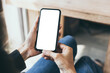 © panitan - cell phone blank white screen mockup.hand holding texting using mobile on desk at office.background empty space for advertise.work people contact marketing business,technology