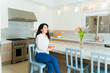 Cheerful relaxed woman enjoying her kitchen