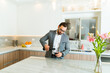 Attractive man drinking wine in a luxury kitchen