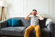 © AntonioDiaz - Smiling man with headphones listening to music at home