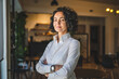 © Miljan Živković - One woman mature caucasian female businesswoman entrepreneur stand at work or home real people copy space wear white shirt curly hair