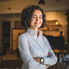 One woman mature caucasian female businesswoman entrepreneur stand at work or home real people copy space wear white shirt curly hair