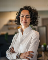 Wall Mural - One woman mature caucasian female businesswoman entrepreneur stand at work or home real people copy space wear white shirt curly hair