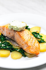 Canvas Print - baked salmon with spinach leaves and potatoes