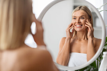 Wall Mural - Anti-Aging Cosmetics. Beautiful Middle Aged Woman Applying Eye Cream At Home