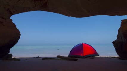 motion time lapse of night camping near sea with moonlight shadow.