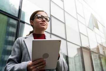 Wall Mural - Portrait female entrepreneur with digital tablet in hands.