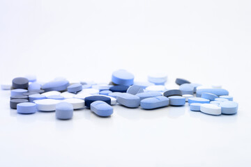 Wall Mural - Assorted pills on a neutral background with light blue colors. Concept of pills used for male erection.