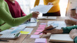 © amnaj - Teamwork. Group of business people brainstorming meeting together with economic report document. Start up business team meeting ideas concept