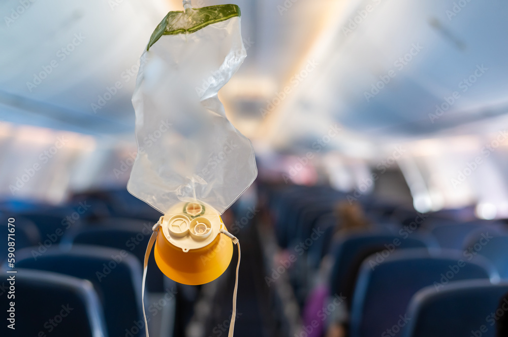 O2 Mask Free Fall oxygen mask drop from the ceiling compartment on airplane.. Stock Photo ...