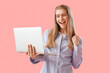 © Pixel-Shot - Happy female programmer with laptop on pink background