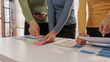 © R Photography - Group of ui ux developer brainstorming website wireframe mobile interface design on desk table.