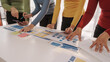© R Photography - Group of ui ux developer brainstorming website wireframe mobile interface design on desk table.