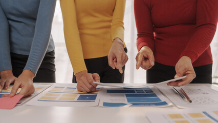 Group of ui ux developer brainstorming website wireframe mobile interface design on desk table.