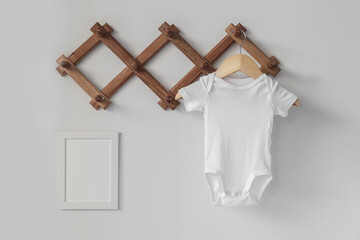 Minimalist white baby short sleeve bodysuit mockup for presentation cute sublimation designs. Minimalistic photos of romper for toddlers in scandinavian boho interior with minimalistic decoration