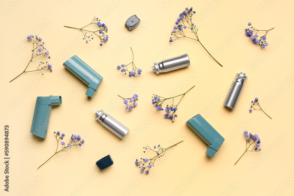 Asthma inhalers with flowers on yellow background