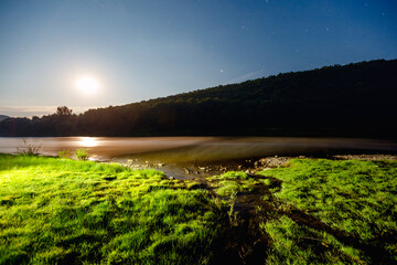 Wall Mural - captivating night landscape with a bright starry sky over the river.