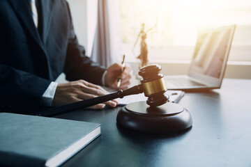 Wall Mural - Business and lawyers discussing contract papers with brass scale on desk in office. Law, legal services, advice, justice and law concept picture with film grain effect