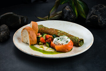 Canvas Print - Fried thin green pancake with salmon, cream cheese, vegetable salad and bread.