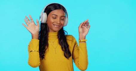 Wall Mural - Woman, music and headphones with dance in studio for listening, relax and sound for peace of mind. Gen z girl, streaming audio and happy student with sexy dancing to internet radio by blue background