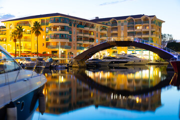 Wall Mural - Twilight in Frejus, South of France. View of Buildings and bridge across Reyran River illuminated by city lights.