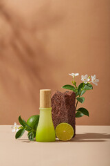 Wall Mural - A jar with gradient color displayed with Lime slice, a stone and white flowers on brown background. Lime (Citrus aurantiifolia) can remove the stratum corneum and dead skin cells