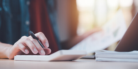 Fototapete - Business people use calculator to calculate documents, profit and loss statement review concept of company performance,effective tax deduction planning for individuals and companies paying tax rates