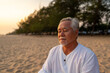 © CandyRetriever  - Asian senior man practicing meditation with ocean nature on tropical beach at summer sunset. Retirement elderly people do outdoor relaxing yoga exercise. Mental health care and motivation concept.