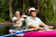 © CandyRetriever  - Asian senior couple using mobile phone taking picture together during kayaking in the river at mangrove forest. Retired elderly man and woman enjoy outdoor lifestyle travel nature on summer vacation.