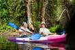 © CandyRetriever  - Asian senior couple kayaking together in the lake at mangrove forest on summer vacation. Retired elderly people man and woman have fun outdoor lifestyle travel nature and rowing a boat in the river.