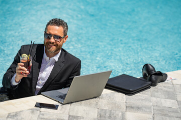 Wall Mural - Businessman in suit with laptop in swimming pool. Crazy business man swimming on summer vacation. Excited businessman in wet suit in swimming pool. Funny business man, crazy comic business concept.