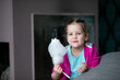© Татьяна Волкова - Smiling, joyful, cute fair haired little girl eat candyfloss, cotton candy and looking at camera indoors. Holiday snack