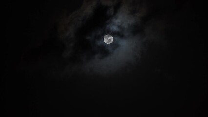 Wall Mural - timelapse of the full moon at night moving through the clouds