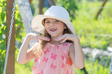 Little girl outdoors, close-up. Portrait of attractive little teen with beautiful happy smiling face. Nature childhood leisure concept. Cute child. Summer vacation and happy childhood.