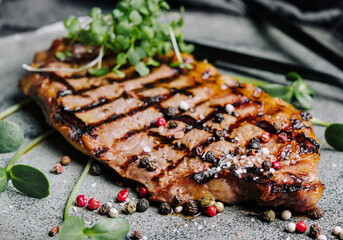 Fried juicy steaks with herbs and spices on plate