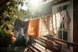 clothesline with freshly laundered towels and sheets hanging in the warm sun, created with generative ai