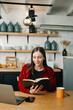 © Nuttapong punna - Asian woman reading book while sitting at  in cafe or home .