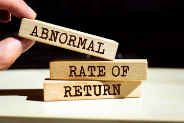 Wooden blocks with words 'Abnormal Rate of Return'.