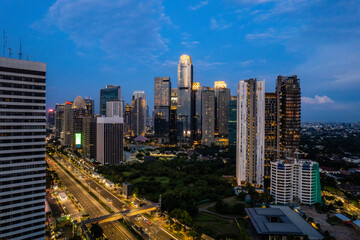 Wall Mural - aerial photos of Sudirman street and Jakarta Skyline in the golden hour. 