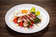 © Jacek Chabraszewski - Sunny side up egg and asparagus wrapped in bacon on wooden background